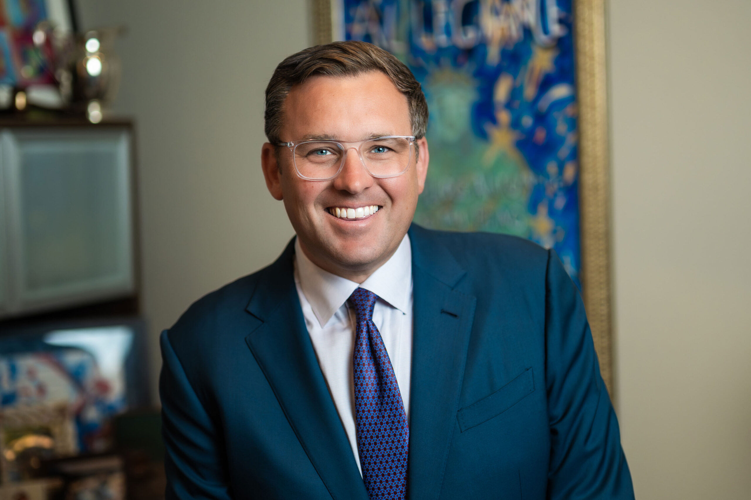 Jacob Stuart Jr., managing attorney at Jacob Stuart Law, smiling confidently in his Orlando office